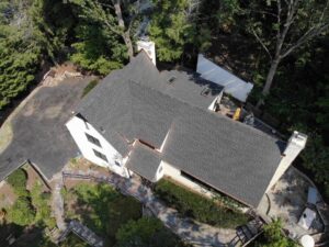 Aerial view of white home with GAF asphalt shingle replacement