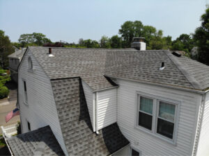 Section of roof on white home with GAF asphalt shingles