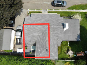 Aerial view of home with a section of roof replaced