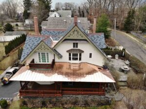 Aerial view of home with copper roof and asphalt shingles in Cos Cob