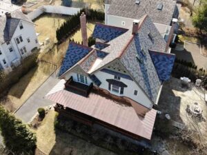 Overhead view of home with copper roof and asphalt shingles