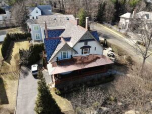 Aerial view of home with copper roof and asphalt shingles