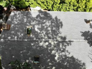 Overhead view of shaded section of roof with asphalt shingles