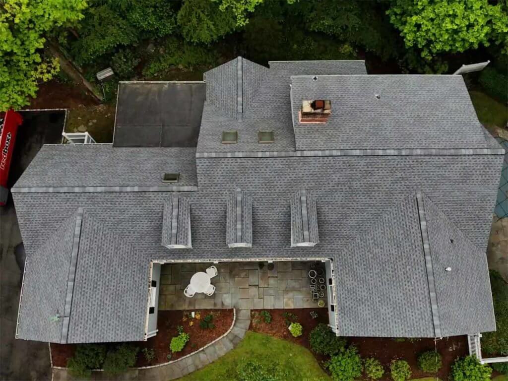 Aerial view of home with asphalt roof in Darien, CT