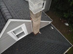 Overhead view of section of roof with dark gray GAF asphalt shingles 