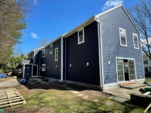 Rear of home with blue royal vinyl siding in Eastchester, NY