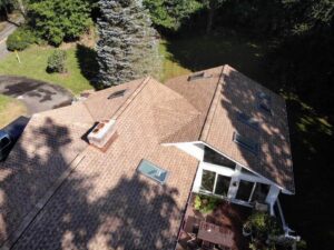 View of section of roof with GAF shakewood asphalt shingles on home