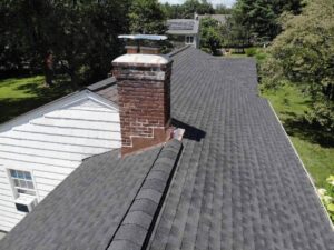 View of GAF asphalt roof and chimney on home in Old Greenwich, CT