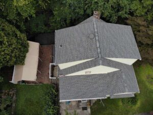 aerial view of home with gray asphalt shingles