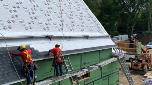 Gunner roofing contractors install shingles on roof