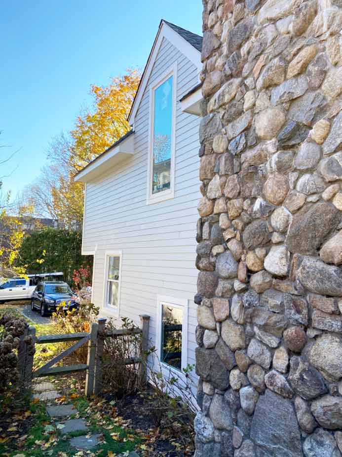 Home with rock wall and James Hardie siding