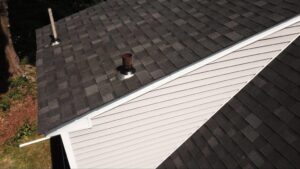 Rooftop with asphalt shingles and pipe boots in place