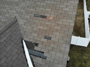 Overhead view of roof with missing shingles