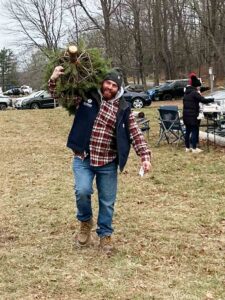 Anthony carrying a tree