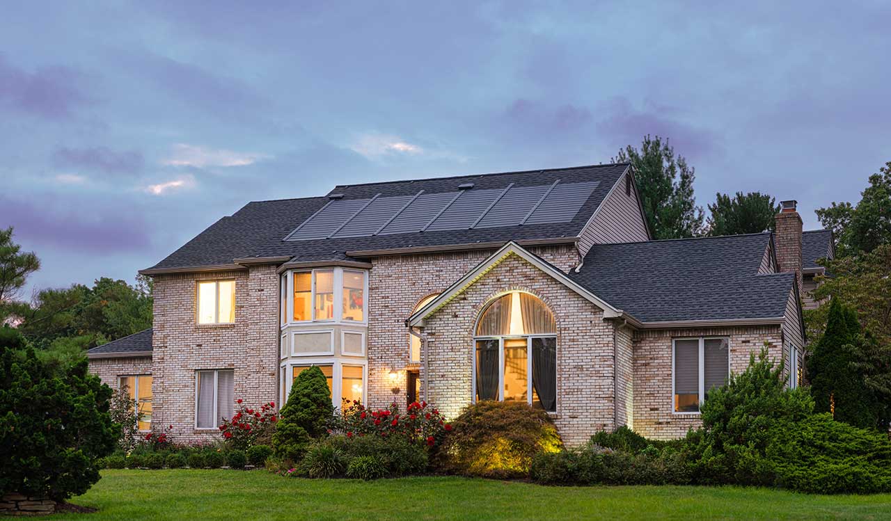 Home at dusk with GAF Timberline solar shingles