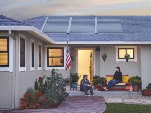 Couple sitting on back porch of home with GAF Timberline solar shingles