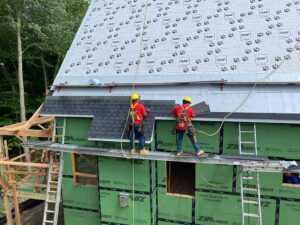 gunner team installing shingles on roof