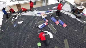 up close of guys putting on shingles in provo utah
